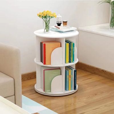 a small white table with books on it