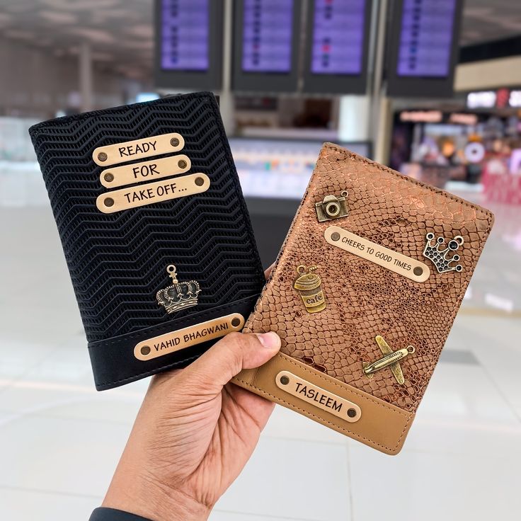 two handmade passport covers are shown in the airport