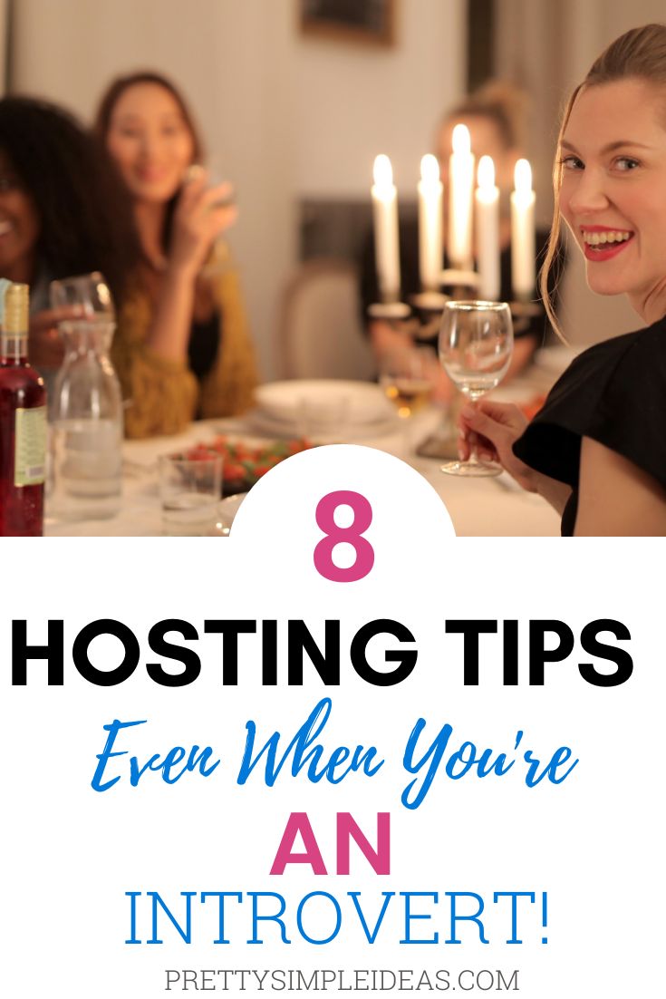 people sitting at a table with candles and wine glasses in front of them, text reads 8 hosting tips even when you're an introvert