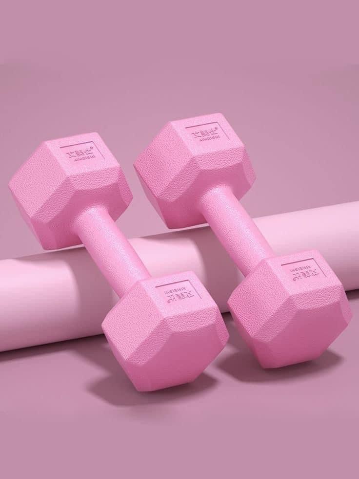 two pink dumbbells sitting next to each other