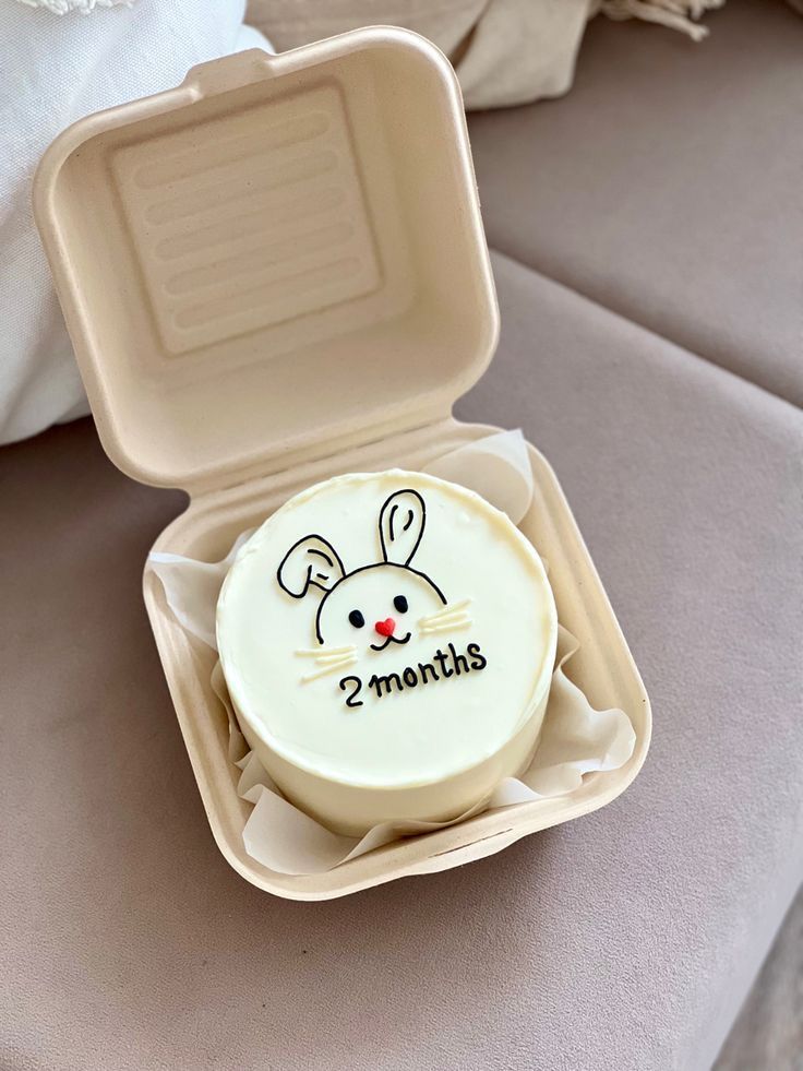 a cake in the shape of a box with an image of a mouse on it