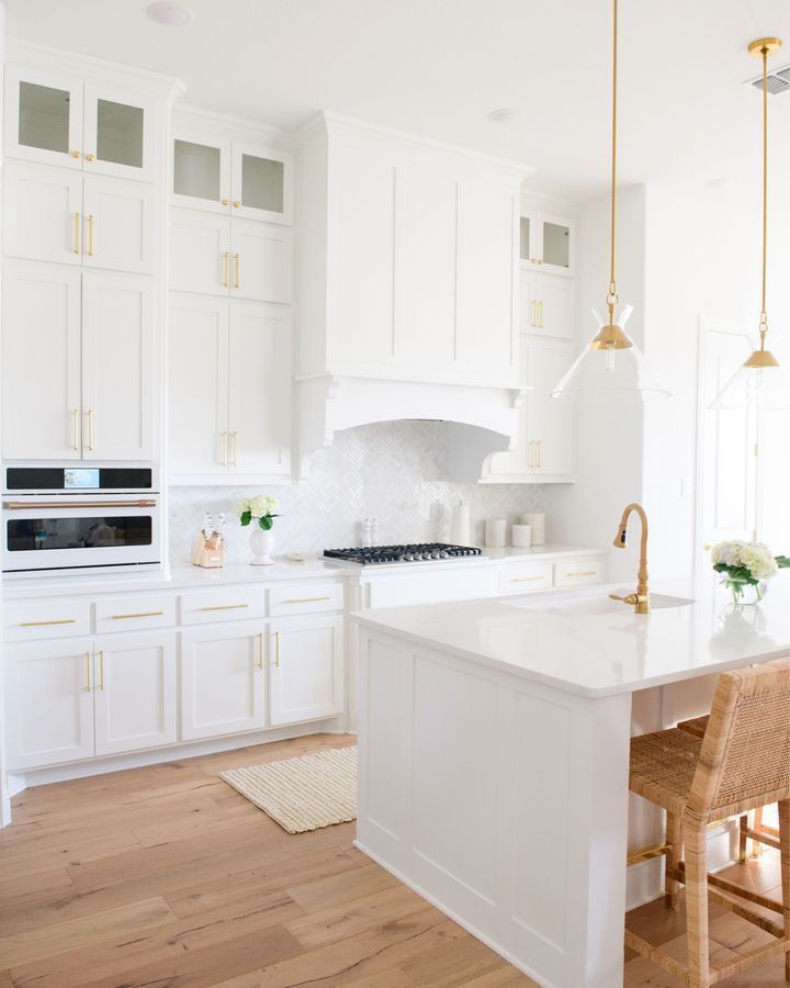 the kitchen is clean and ready for us to use it's white cabinets, counter tops, and appliances