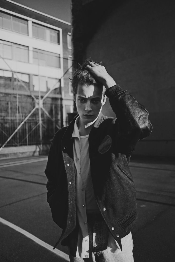 black and white photograph of a man walking down the street with headphones in his ears