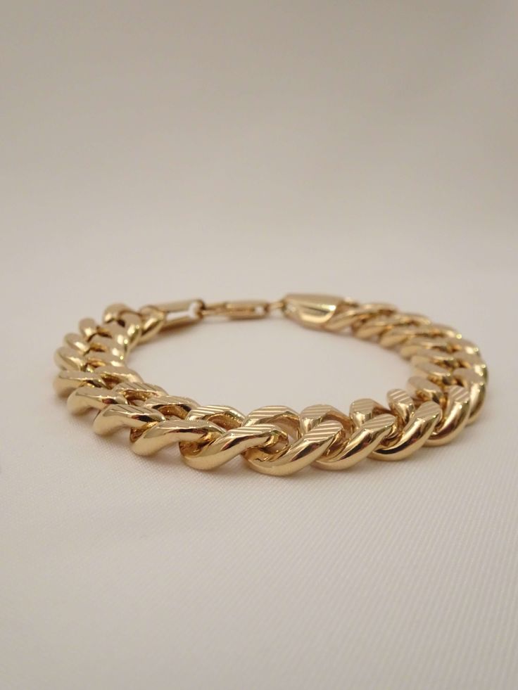 Define your rebellious style with The Benjamin Chain Bracelet! This bold accessory is designed for those who dare to push boundaries, featuring a unique blend of edginess and trailblazing charm. Nail your look every time with this unisex gold chain bracelet. This cool bracelet features bold diamond cut chain links and is the perfect women's or men's gold chain link bracelet that packs a punch! Complete your look by stacking it with these chain bracelets: - The Kennedy Chain Bracelet - The Elliot Trendy Stainless Steel Gold Chain Bracelet, Trendy Stainless Steel Chain Bracelet With Gold Chain, Bold Metal Bracelets For Gift, Bold Metal Jewelry For Everyday, Trendy Link Bracelet With Curb Chain, Trendy Curb Chain Link Bracelet, Trendy Metal Chain Bracelet With Curb Chain, Trendy Metal Curb Chain Bracelet, Trendy Cuban Link Gold Chain Bracelet