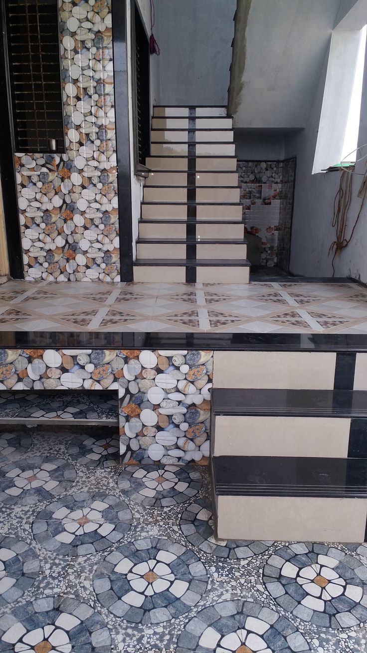 a set of stairs in front of a tiled wall