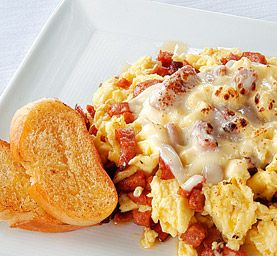 an egg casserole on a white plate with bread