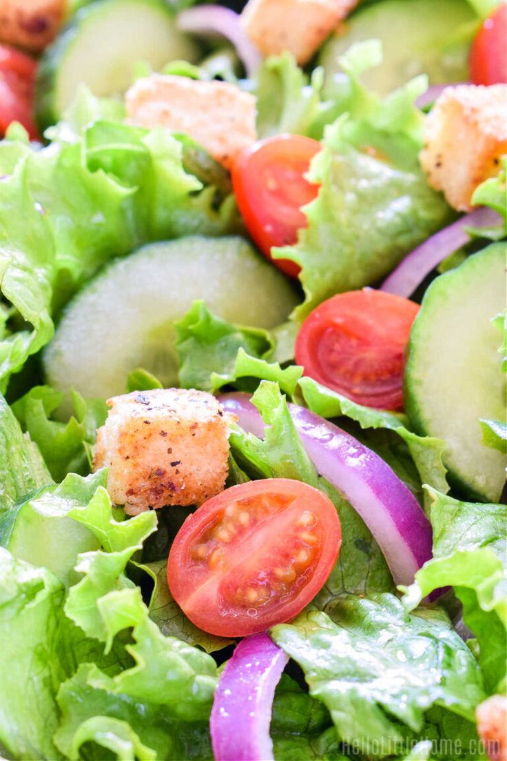 a salad with lettuce, cucumber and tomatoes