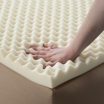 a person reaching for the bottom of a mattress