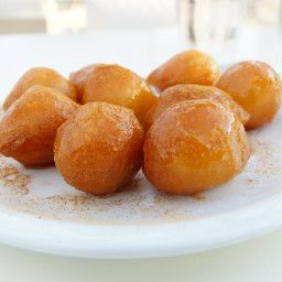 a white plate topped with donuts covered in sugar