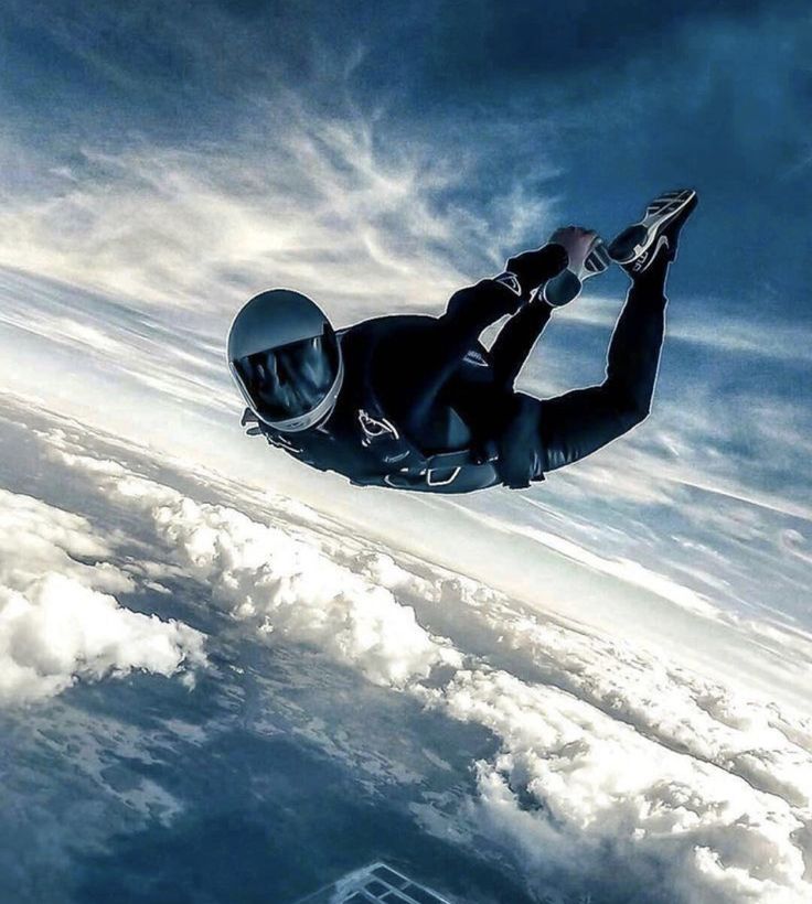 a man in black suit flying through the air