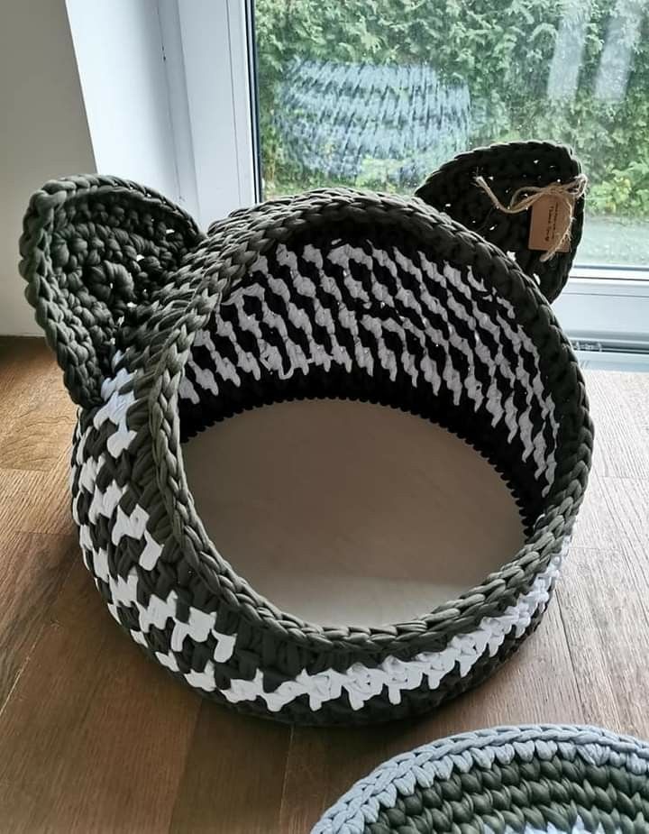 three woven baskets sitting on top of a wooden floor next to a window with trees in the background