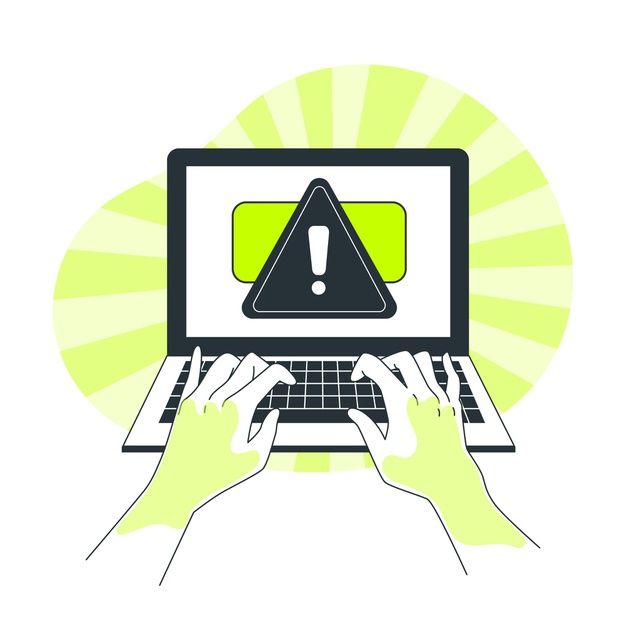 two hands are typing on a laptop with a warning sign above the keyboard and mouse