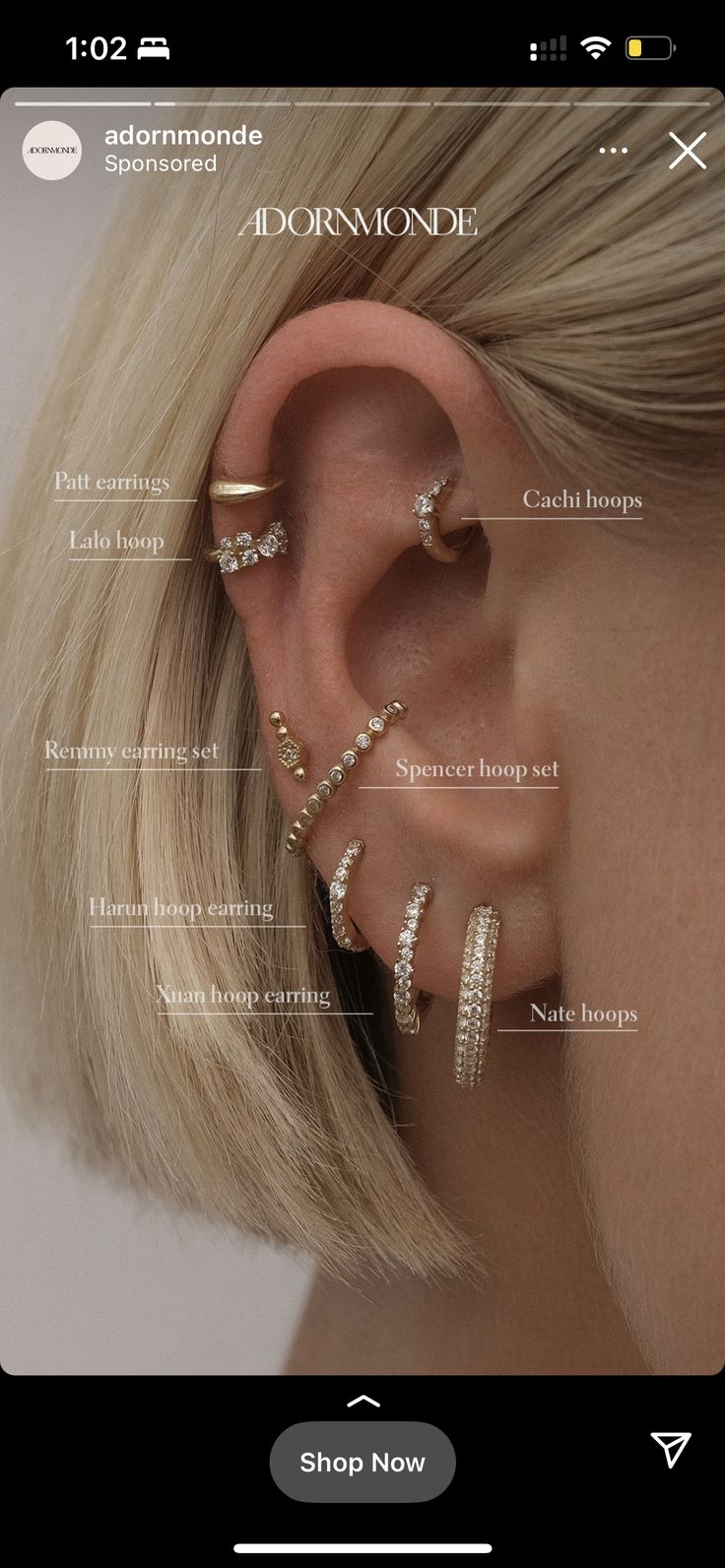 a woman with blonde hair wearing ear piercings and an earring set in front of her face