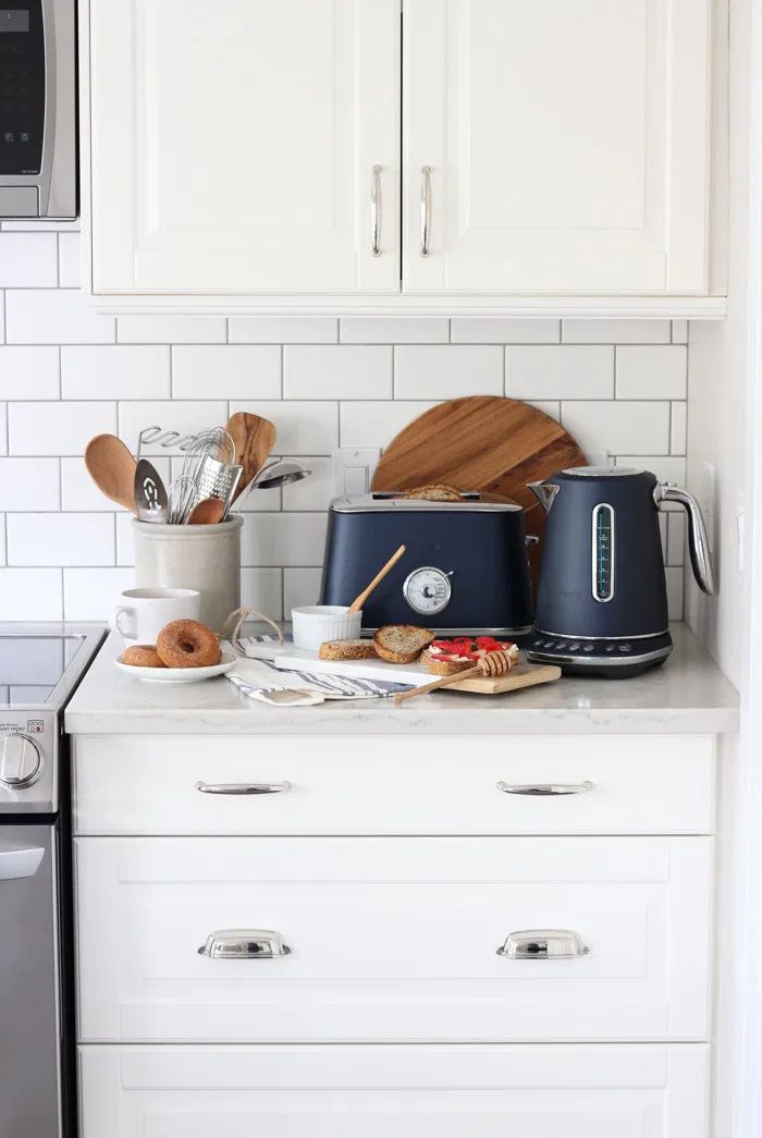 the kitchen counter is cluttered with cooking utensils