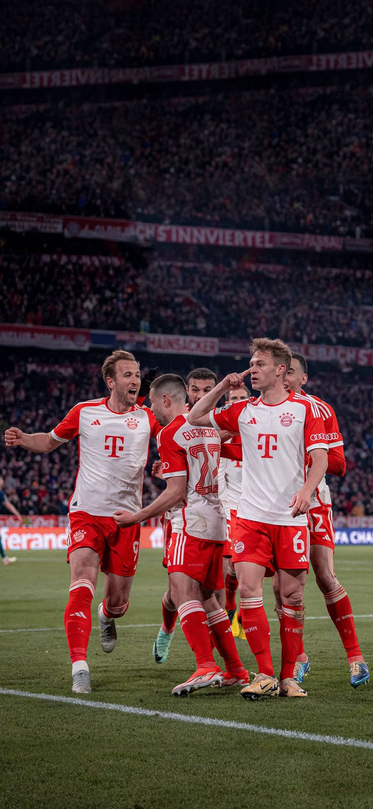 a group of men standing on top of a soccer field