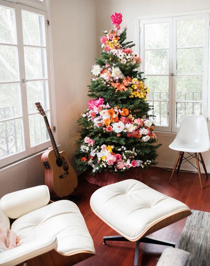 an image of a christmas tree with flowers on it