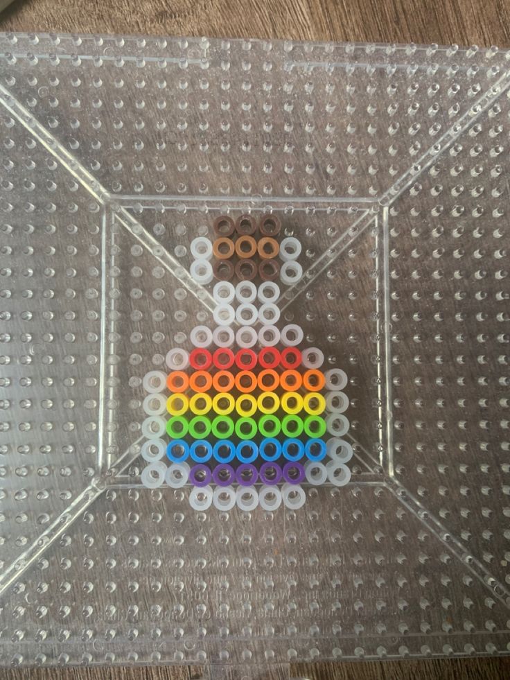 an object made out of legos on top of a plastic tray with holes in the middle