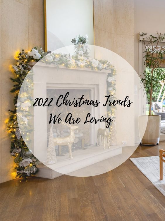 a living room filled with furniture and a fire place covered in christmas decorations on top of a hard wood floor