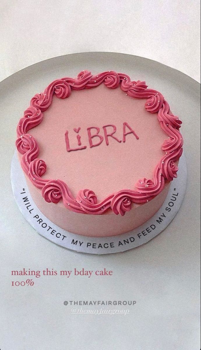 a pink cake with the word libra written on it in cursive writing