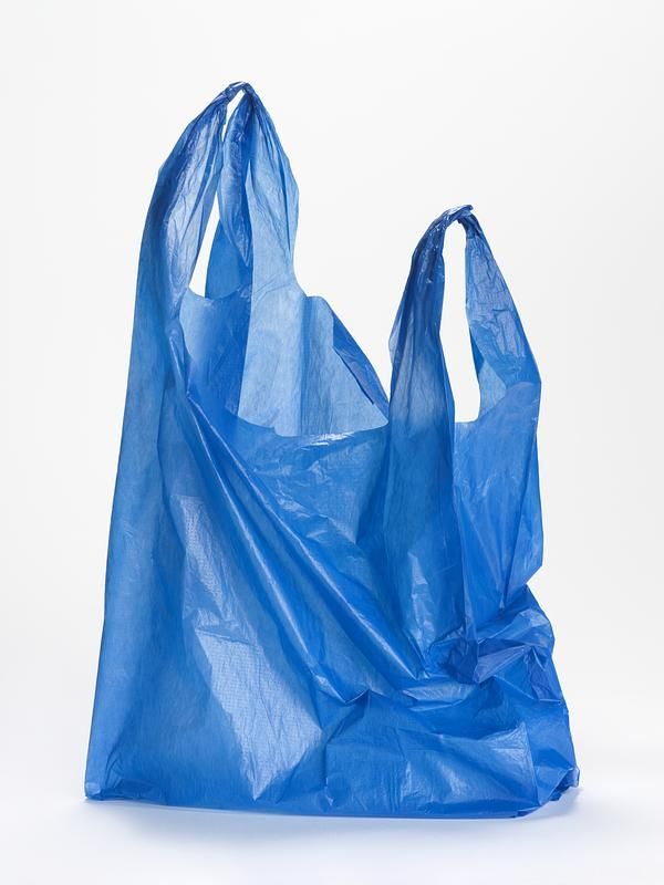 a blue plastic bag sitting on top of a white table