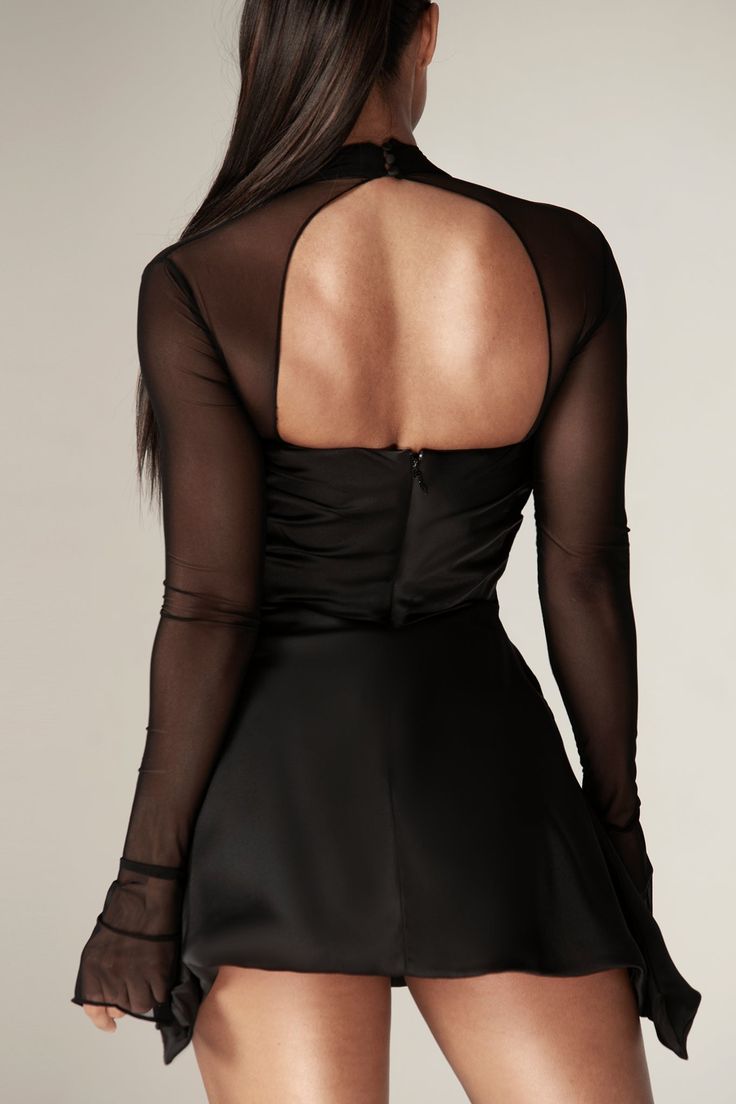 Our 'Maya' mini dress is so fun and flirtatious, making it perfect for romantic date nights. Made from our soft silk satin in a black hue, 'Maya' is cut on the bias and has so many pretty details. The cross front halter shape is so flattering and creates a skin baring open front with a beautifully draped cowl neckline, fitted with our incredible corsetry boning to really cinch the waist.The dramatic sleeves have flared cuffs and 'Maya' is fully lined for comfort, with a zip and button fastening Draped Corset, Dramatic Sleeves, Corset Mini Dress, Romantic Date, Pretty Prom Dresses, Mini Dress Black, Cowl Neckline, The Cross, Mini Black Dress