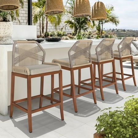 a set of four bar stools sitting on top of a white tiled floor next to an outdoor kitchen