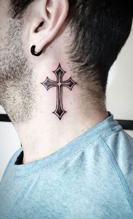 a man's neck with a cross tattoo on the back of his neck and behind his ear