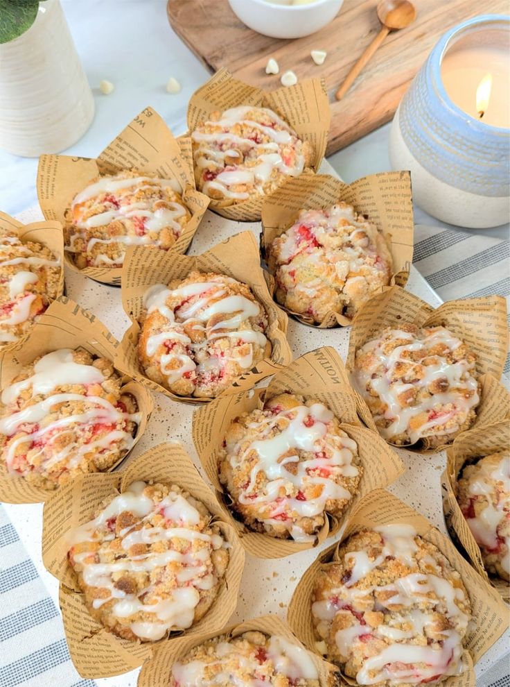 a table topped with muffins covered in frosting