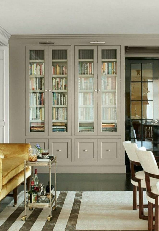 a living room filled with furniture and bookshelves