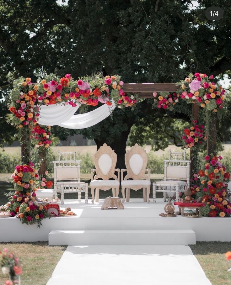 an outdoor wedding setup with chairs and flowers