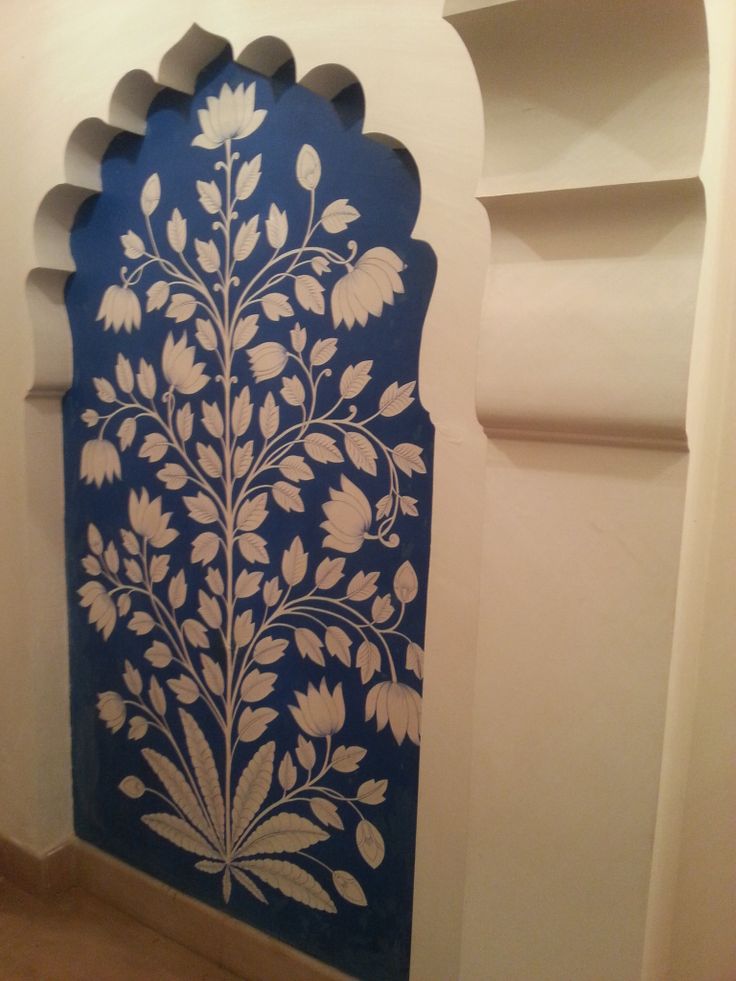 a blue and white wall hanging on the side of a building