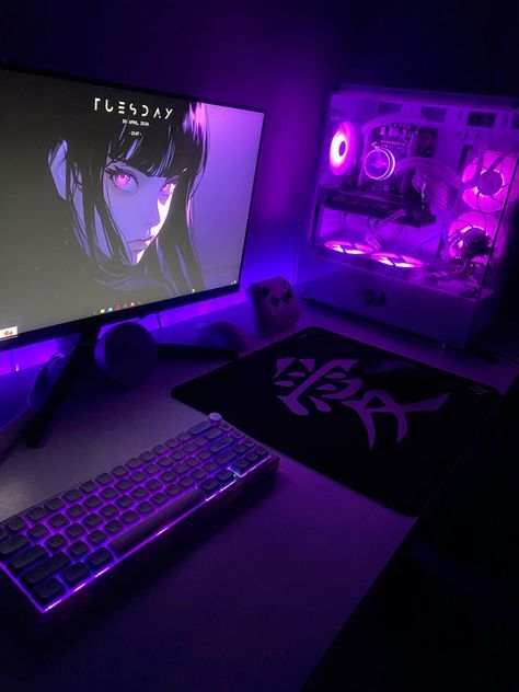 a desk with a keyboard, mouse and monitor on it in front of a purple light