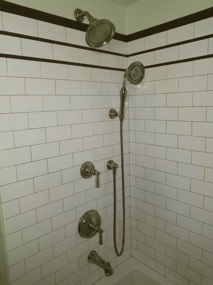 the shower head and handset are connected to the faucet in this bathroom