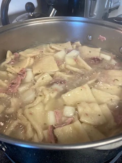 a pot filled with food sitting on top of a stove