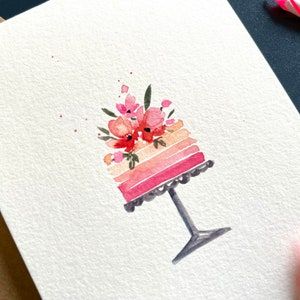 a watercolor painting of a cake with flowers on it and a person's hand next to it