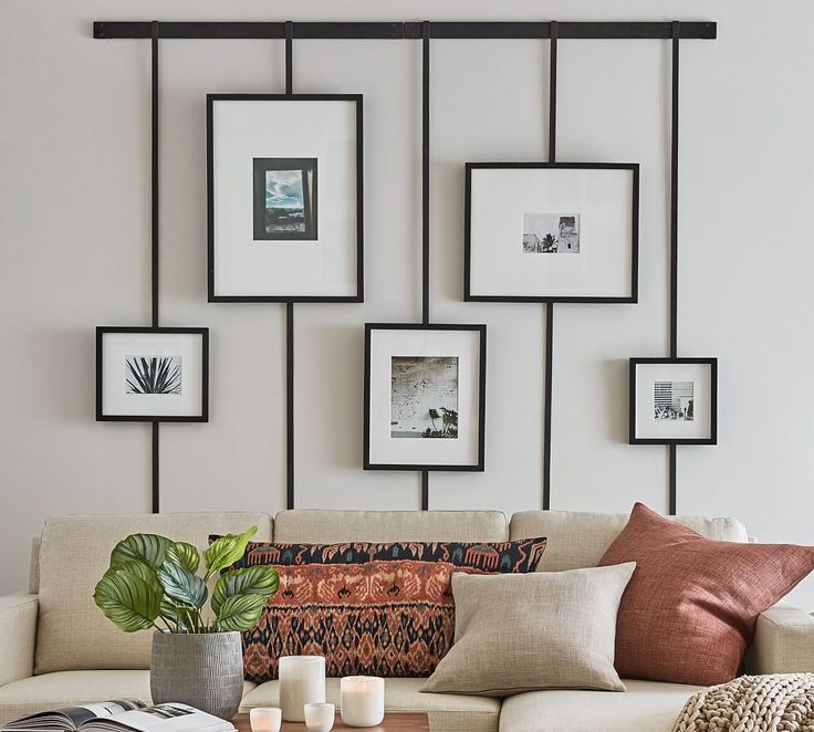 a living room filled with lots of furniture and pictures on the wall above it's coffee table