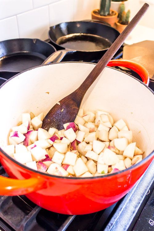 the food is being cooked in the pot on the stove