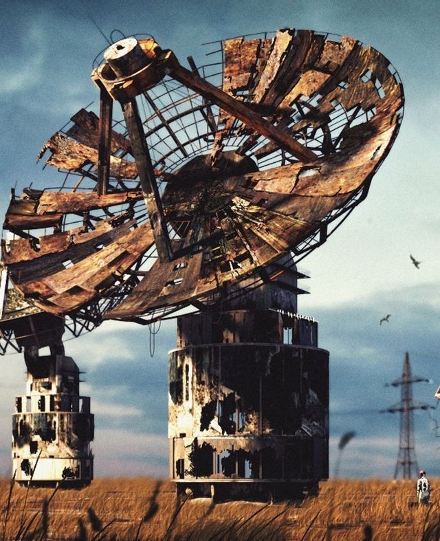 an old satellite dish sitting in the middle of a field with birds flying around it