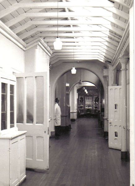 an old black and white photo of a hallway