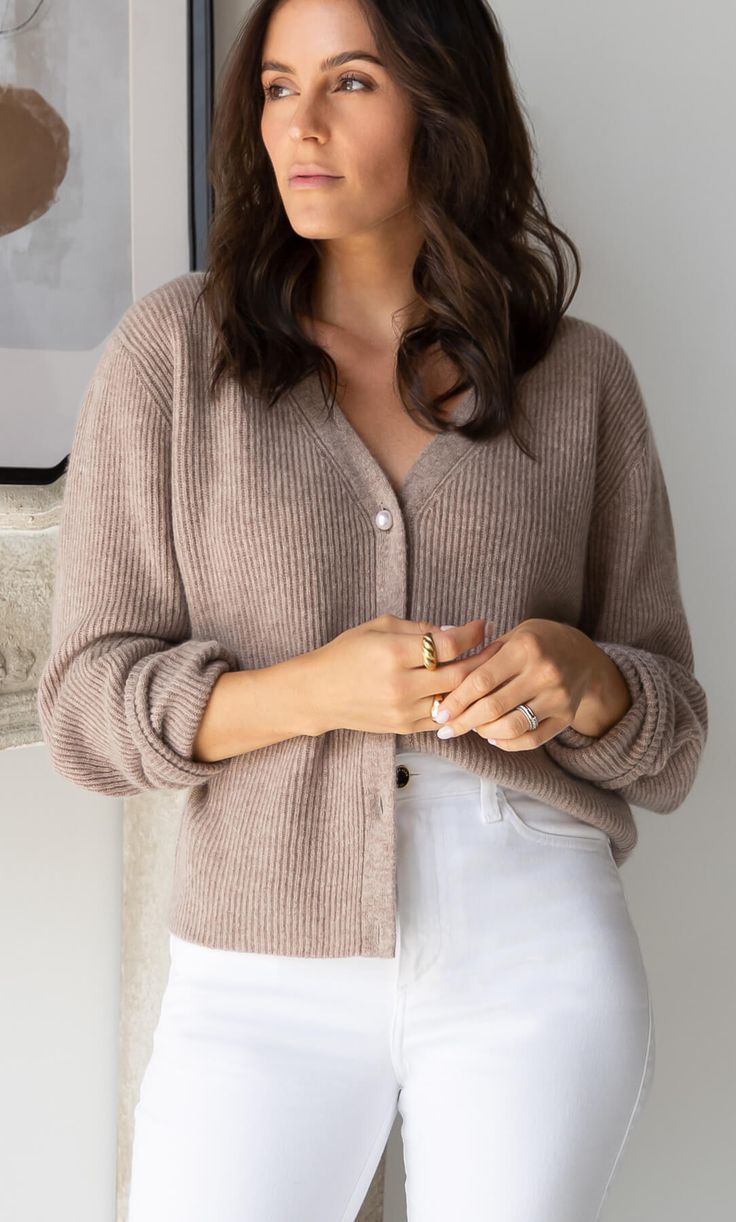 A timeless, versatile classic that layers beautifully with just about any outfit for an effortlessly chic look. Knit with supremely warm and lightweight cashmere, you won't want to leave home without it. V-neck cardigan with elegant ribbed knit. White pearlescent buttons. Hits at the hips. Wear open or buttoned up. FIT: Relaxed fit. Size down if you're between sizes. 100% LUXURY CASHMERE Silk Slip Skirt, Cashmere Winter Scarf, Silk Tee, Cashmere Pants, Cashmere Socks, Cashmere Beanie, Silk Pajama Set, Cashmere Turtleneck, Silk Slip Dress