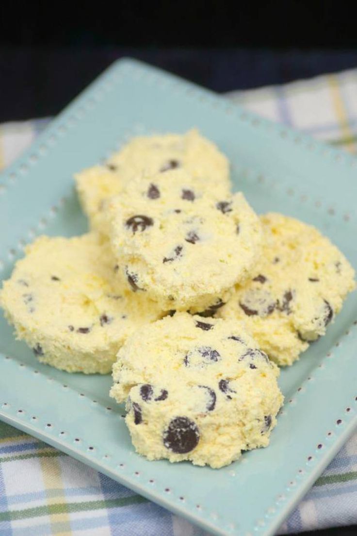 three cookies with chocolate chips on a blue plate