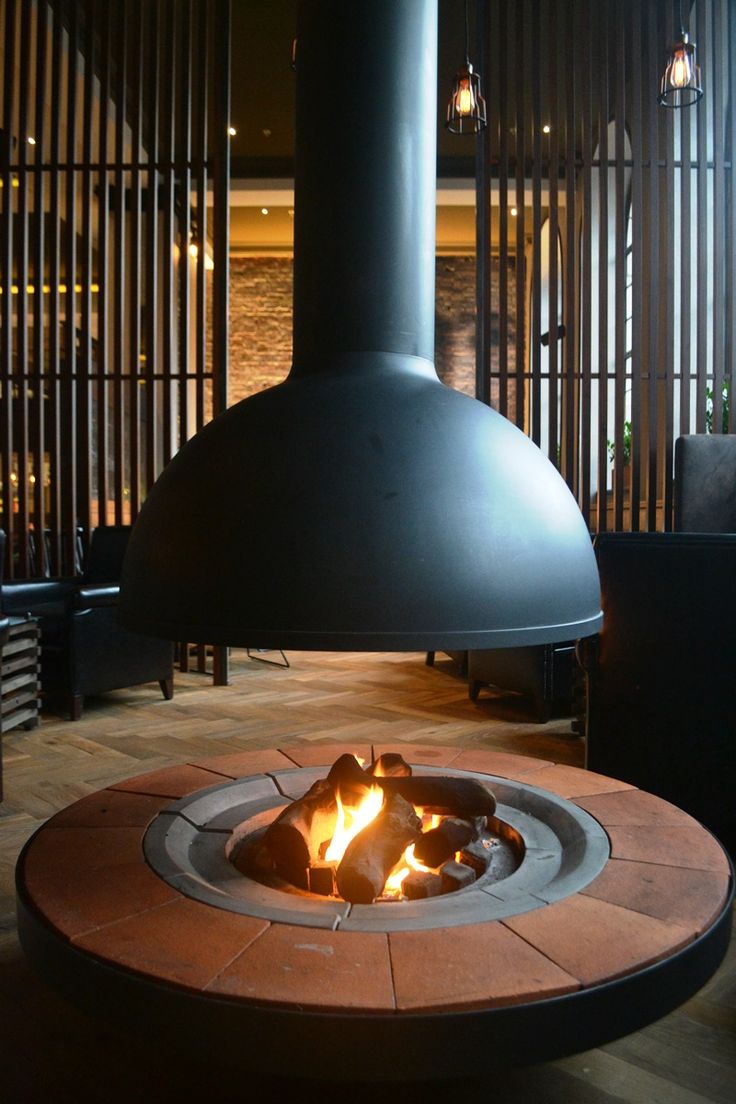 a fire pit sitting in the middle of a living room