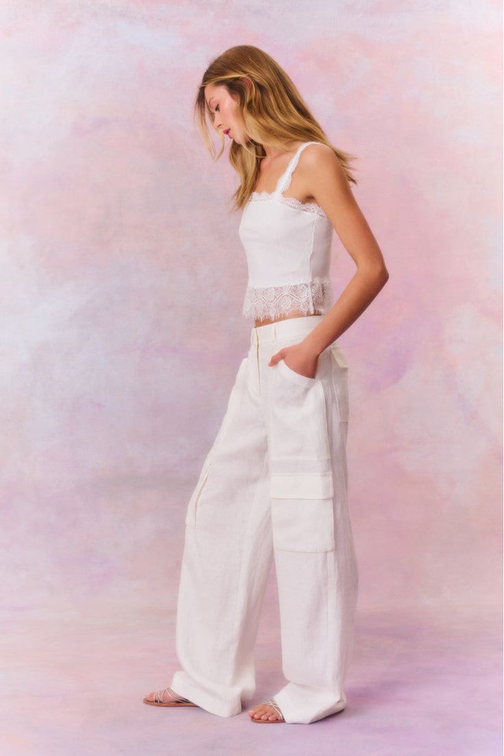 Introducing the Pora Pant. These sophisticated pants are designed from a crisp linen fabric for easy and comfortable wear. The straight leg cargo pant features pockets on each leg, pockets on the side and a center front zipper. Linen Cargo Pants, Peplum Hem, Silk Charmeuse, Cargo Pant, Front Tie Top, Warm Weather, Linen Fabric, Front Zipper, Cargo Pants