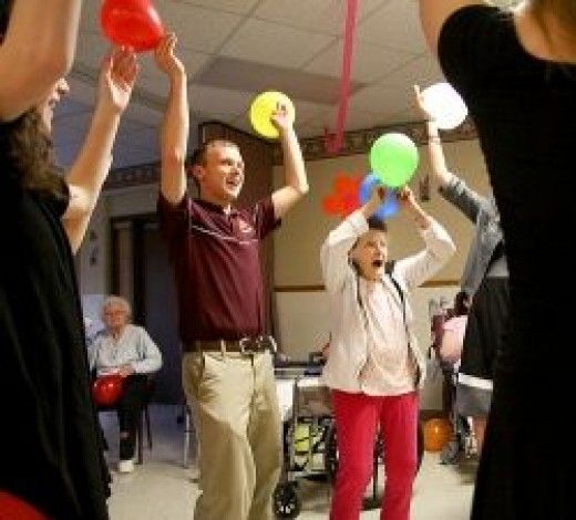 a group of people holding up balloons in the air