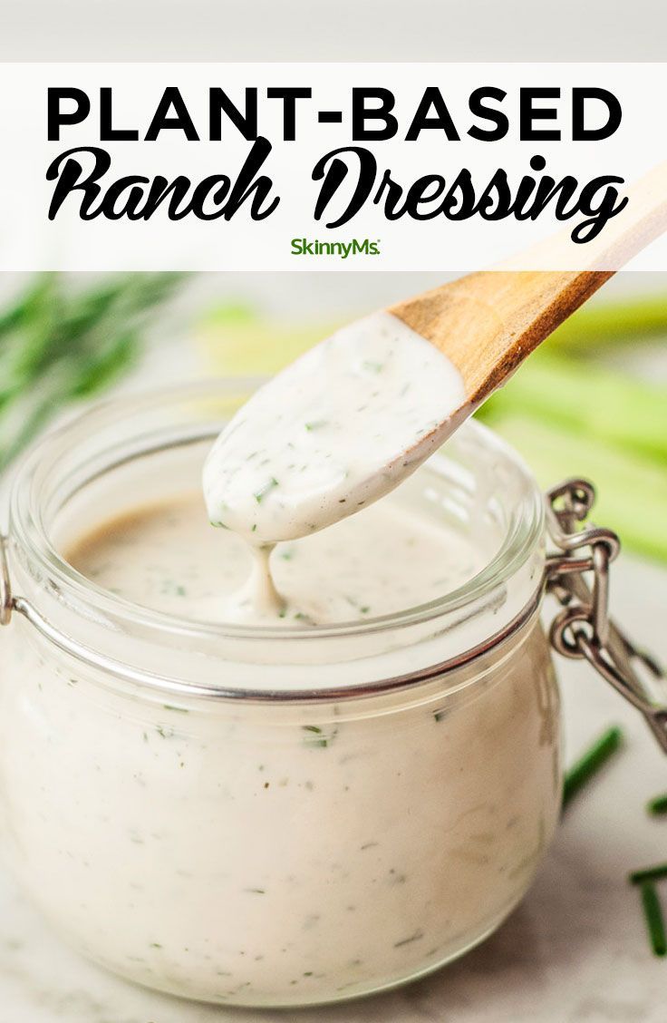 a spoon full of ranch dressing in a glass jar with the words plant - based ranch dressing on it