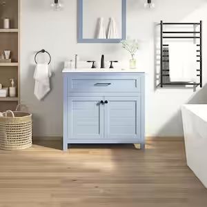 a bathroom with white walls and wooden floors