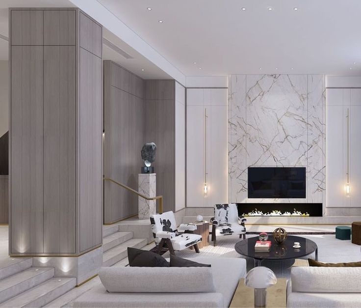 a modern living room with white furniture and marble walls