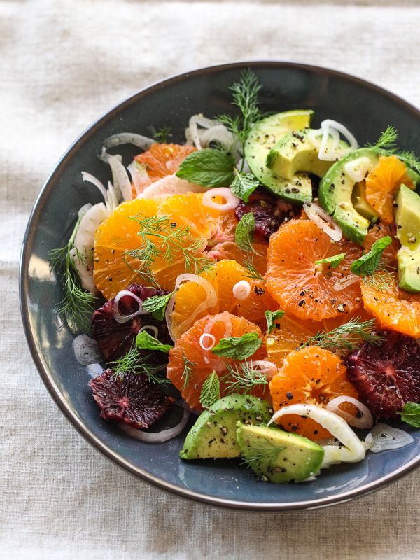 a salad with oranges, avocado and cranberries