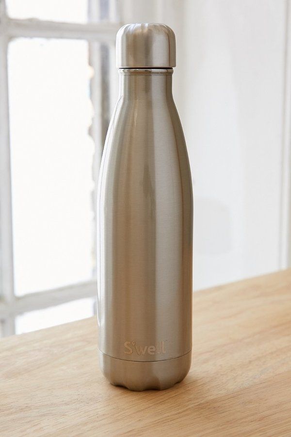 a stainless steel bottle sitting on top of a wooden table