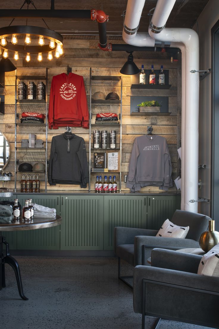 the inside of a barber shop with two chairs and shelves full of products on display